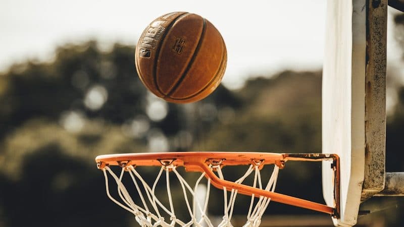 brown basketball on basketball hoop